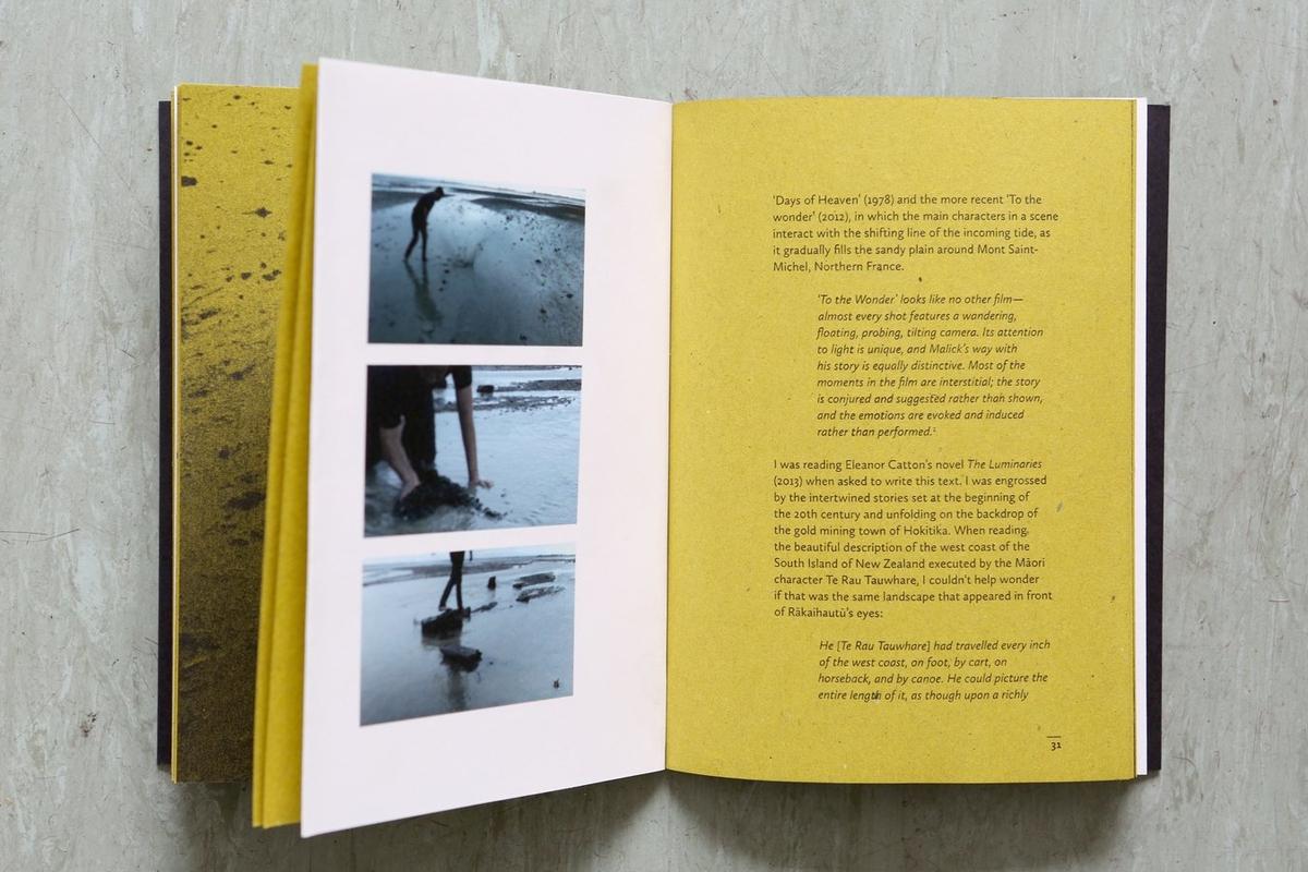 A open book with images of Shannon performing on the sand next to a written response